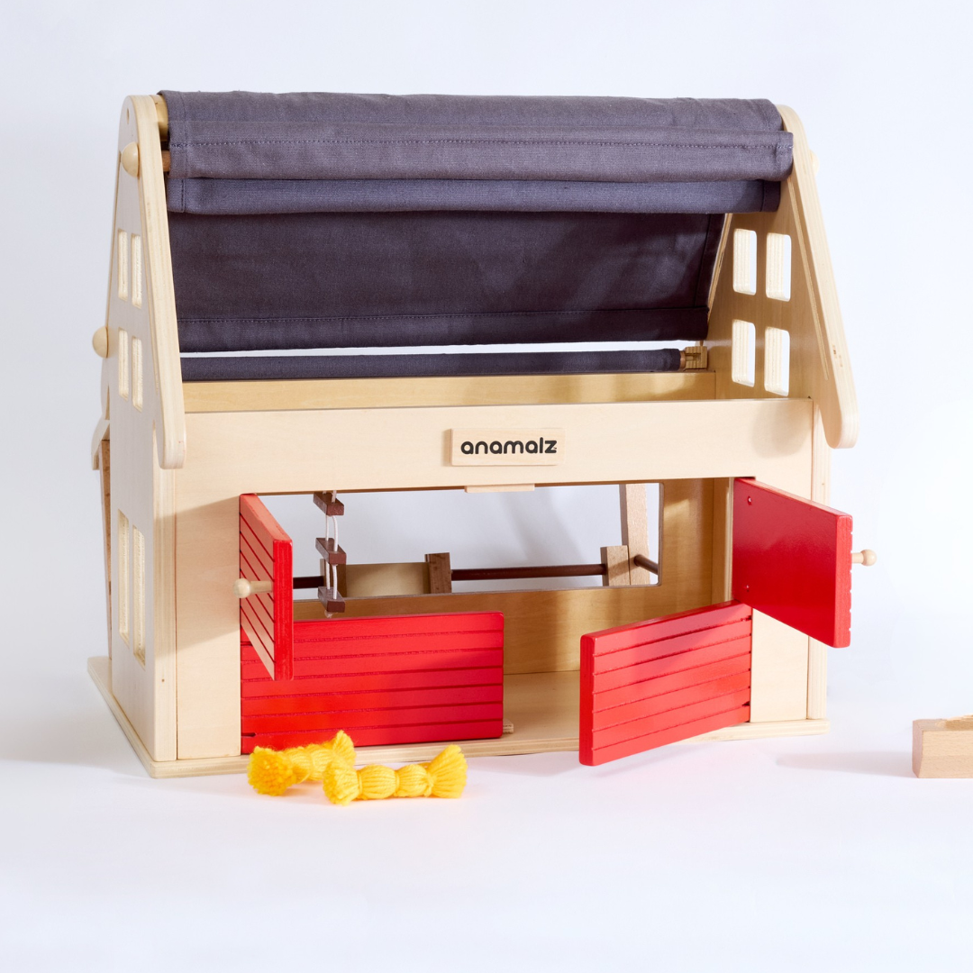 Eco-friendly wooden toy barnhouse designed for farm animal toys – front angled view with doors and windows