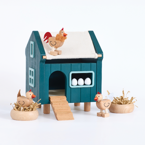 Toy chicken coop with chickens and eggs on a white background