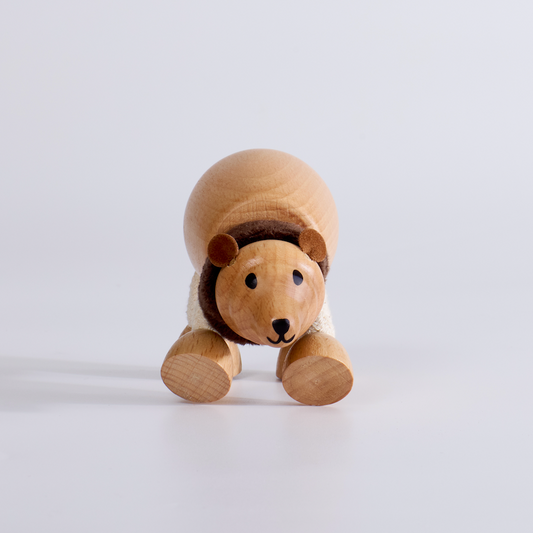 Wooden toy bear on a light gray background