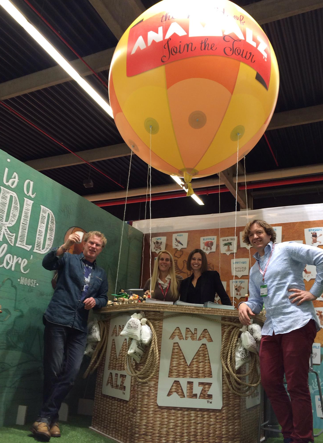 4 people standing in front of stall promoting anamalz toy brand