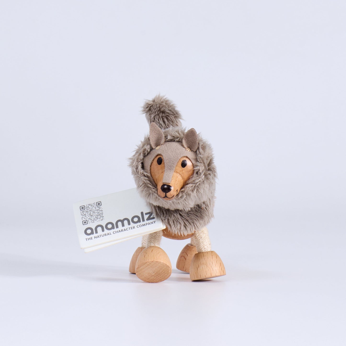 Plush wood toy wolf with a visible brand label on a white background