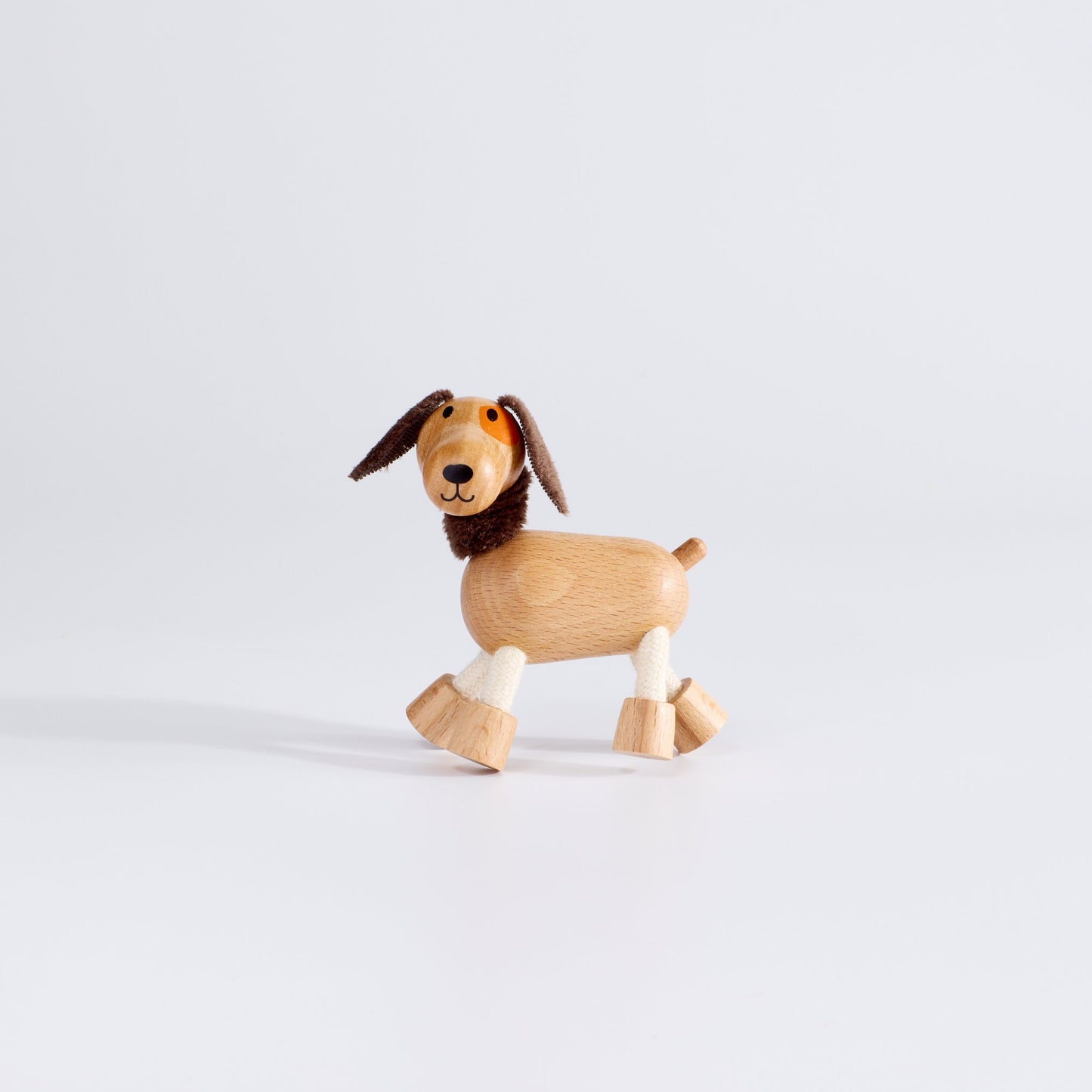 Wooden dog toy on a white background