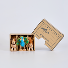 Three small animal figurines in a cardboard box labeled 'Home Team' on a white background