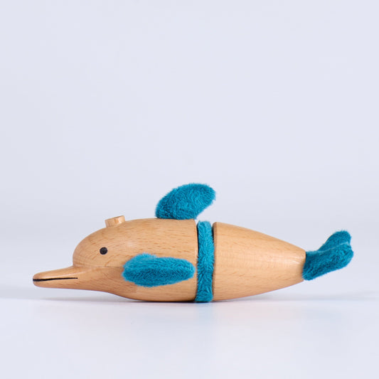 Wooden toy dolphin with blue accents on a white background