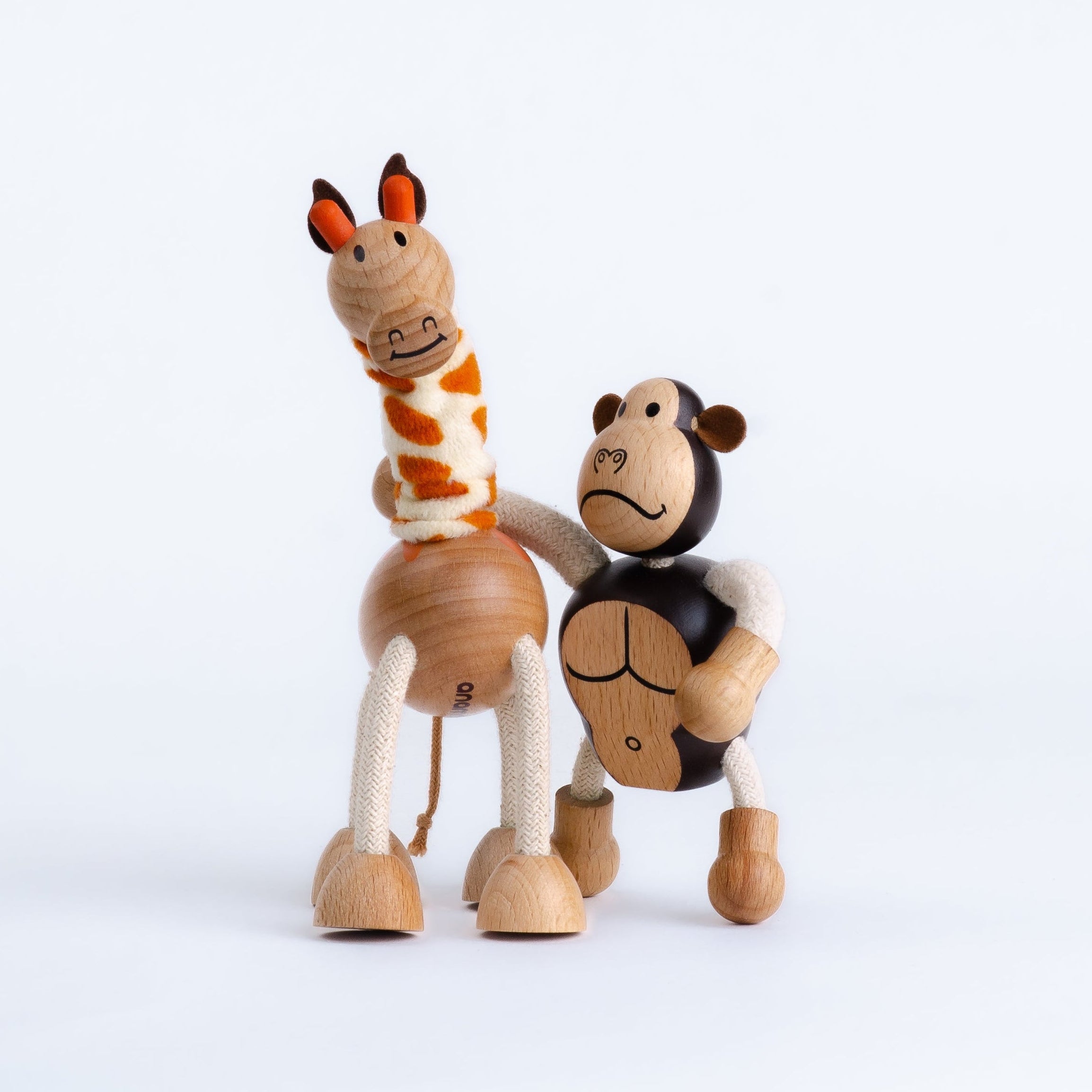 Two wooden toy animals, a giraffe and a horse, on a white background