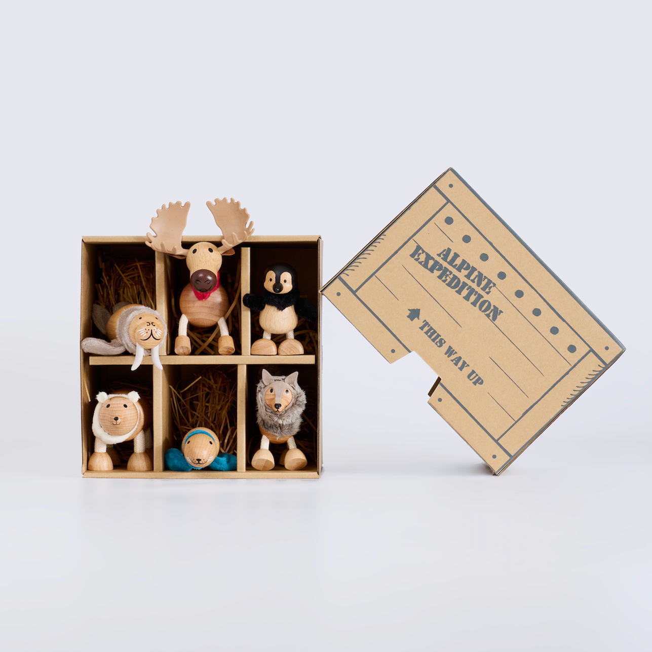 Set of small animal figurines in a cardboard box with 'Alpine Expedition' text on a light gray background