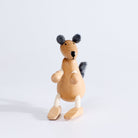 A wooden toy kangaroo with plush fabric and rope, standing upright on a white background.