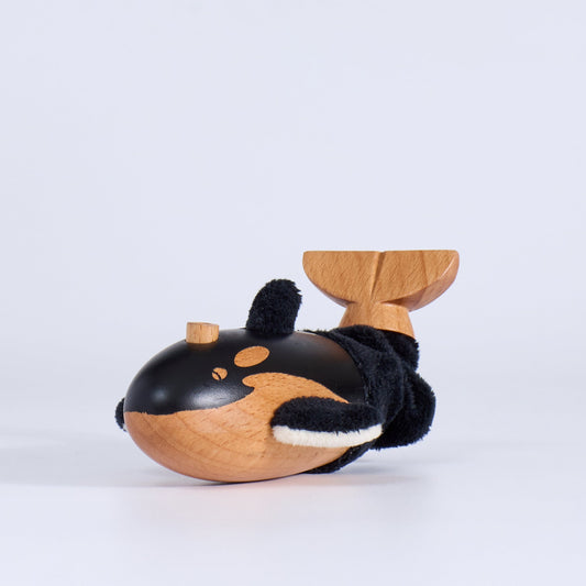 Wooden toy whale on a white background