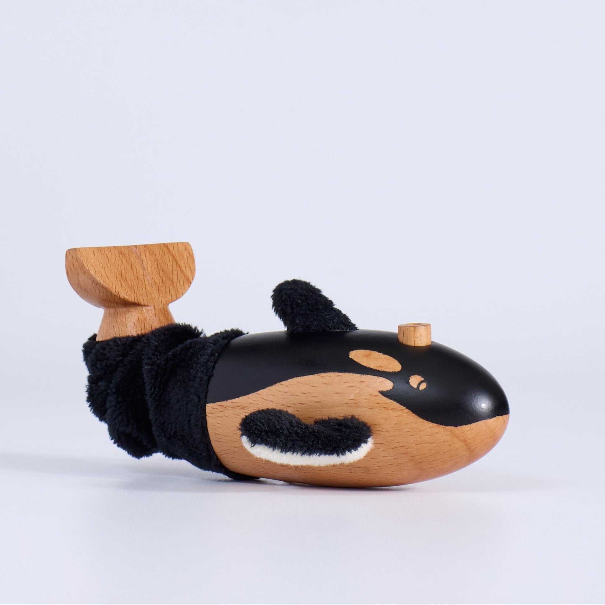 Wooden toy whale on a white background