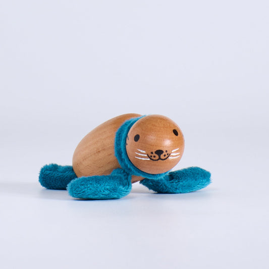 Wooden toy seal with a blue scarf on a white background
