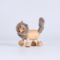 Wooden toy wolf with fur on a white background