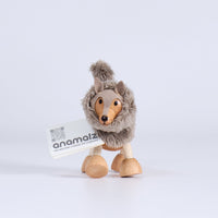 Plush wood toy wolf with a visible brand label on a white background