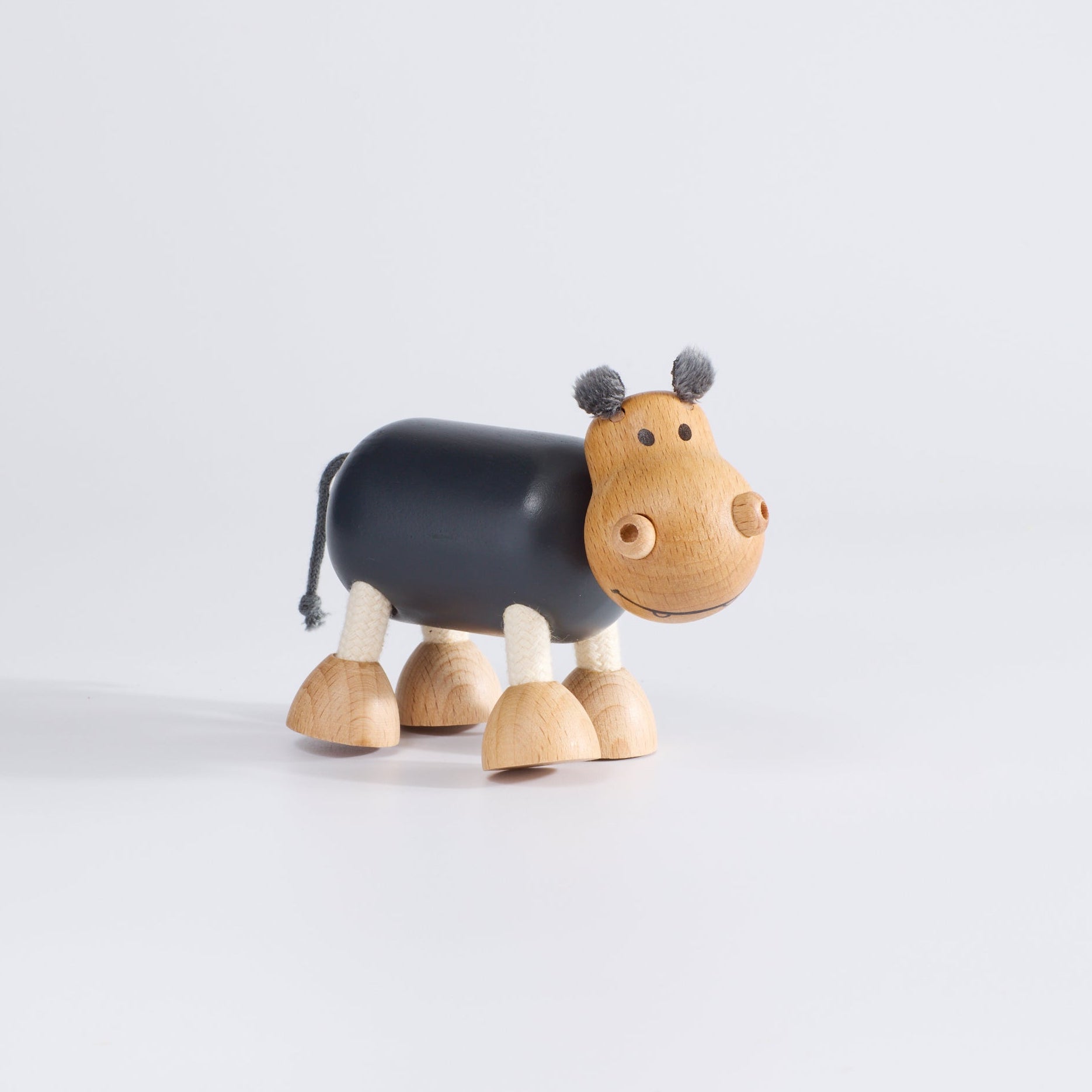 Wooden toy hippo with grey body.