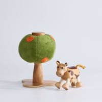 Anamalz Orange Tree toy with a green plush canopy, orange spots, and a wooden trunk and base and a wooden toy cow in front of it