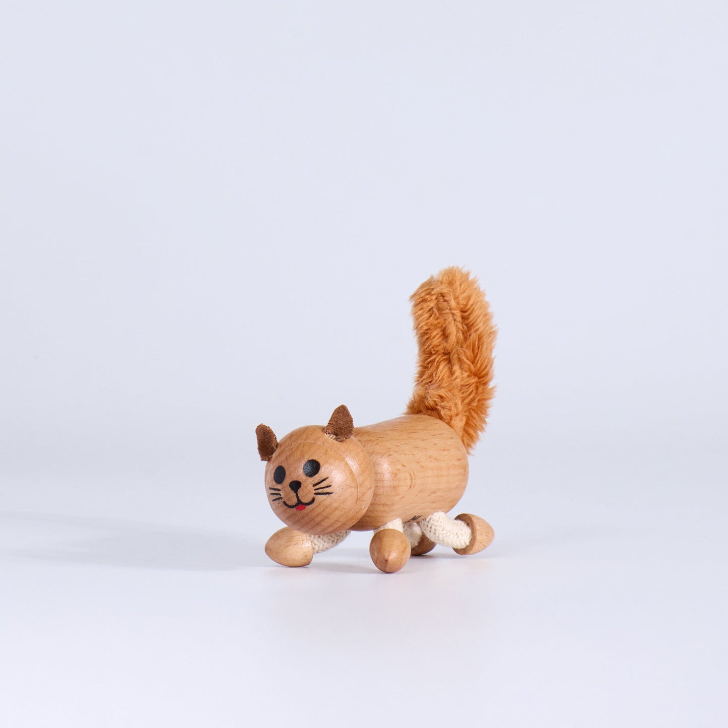 Wooden toy cat on a white background
