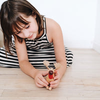 Adorable eco-friendly wooden moose toy with a cheeky smile, perfect for imaginative play and learning