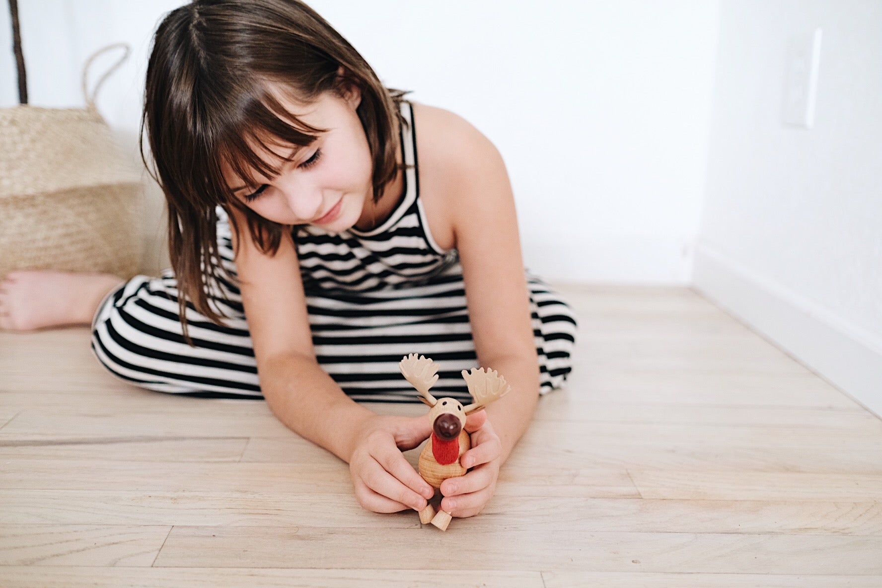 Adorable eco-friendly wooden moose toy with a cheeky smile, perfect for imaginative play and learning